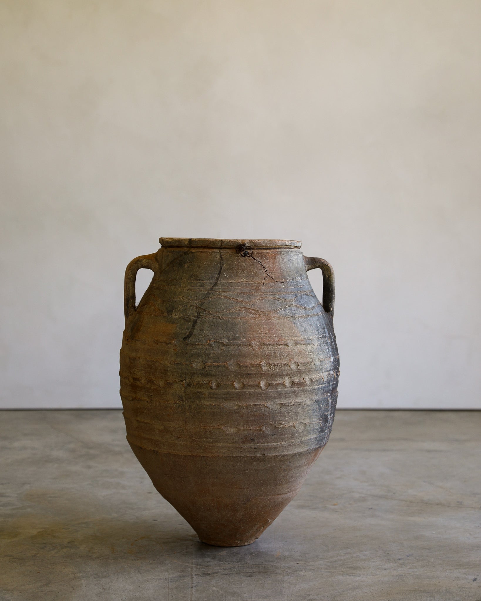 antique turkish handled olive jar with etching details and metal stand