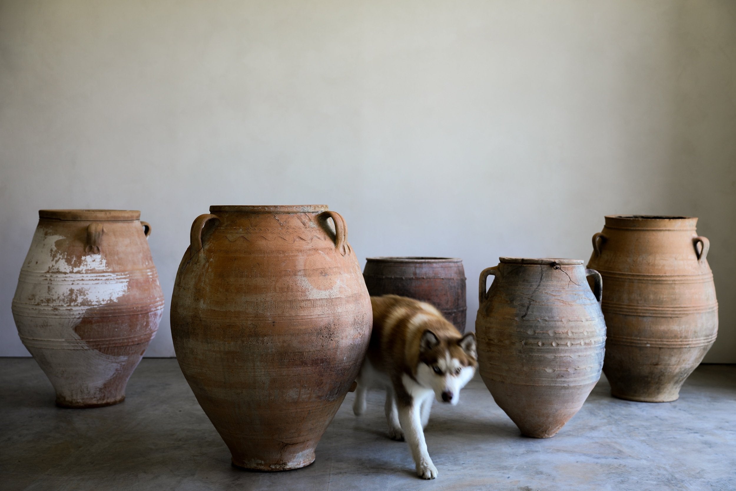 antique turkish urn grouping in studio with natural patinas and etched detailing