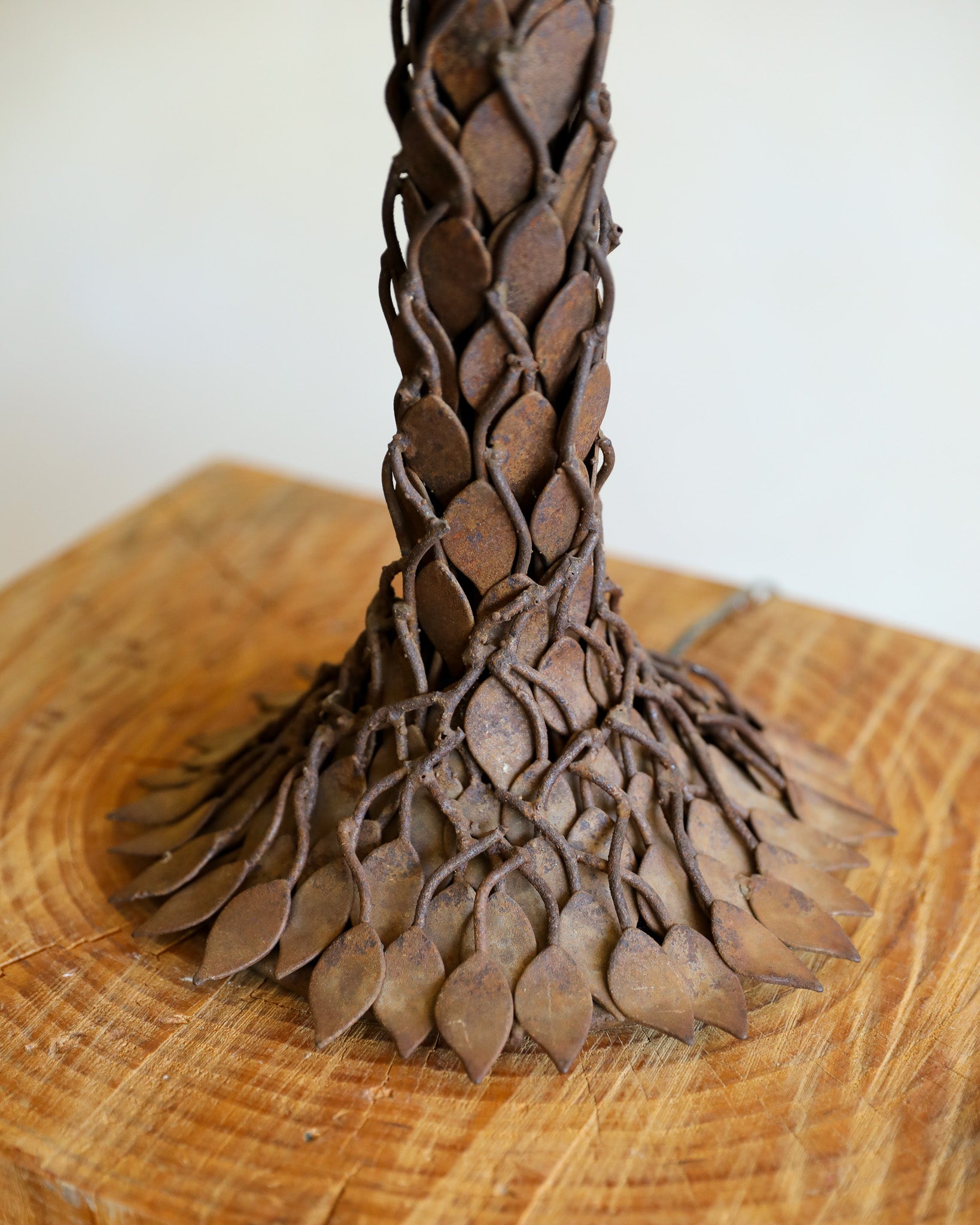 close up detail of base of textural metal table lamp with leaf details