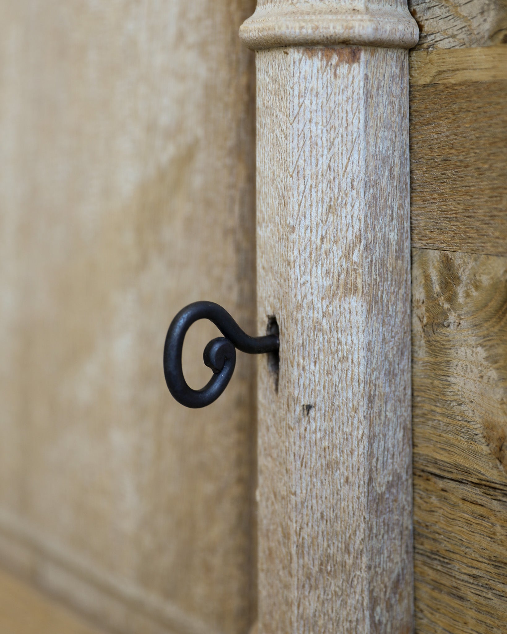 vintage french carved wood and iron highboard key in door detail