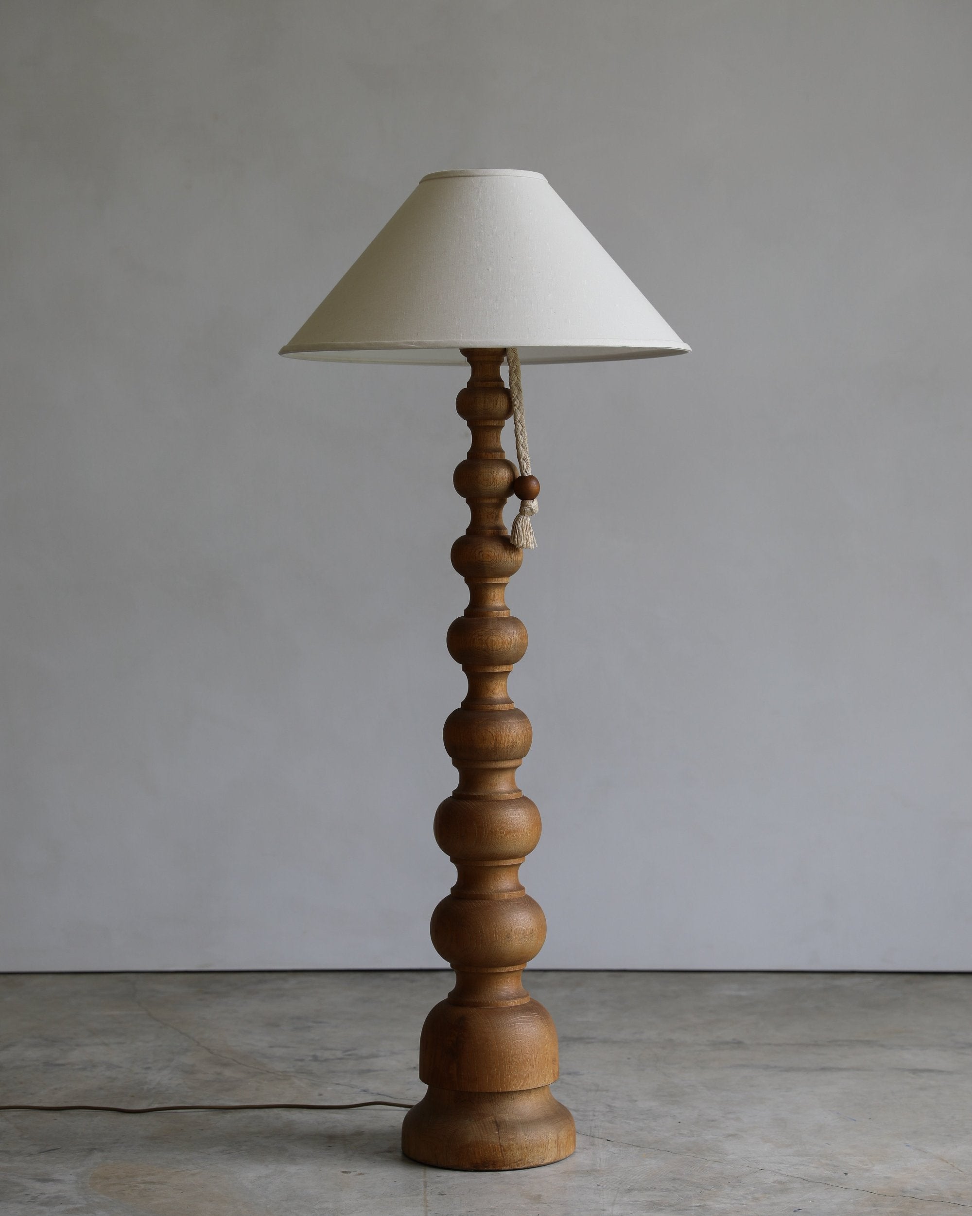 vintage turned wood floor lamp with rope pull detail and linen coolio shade