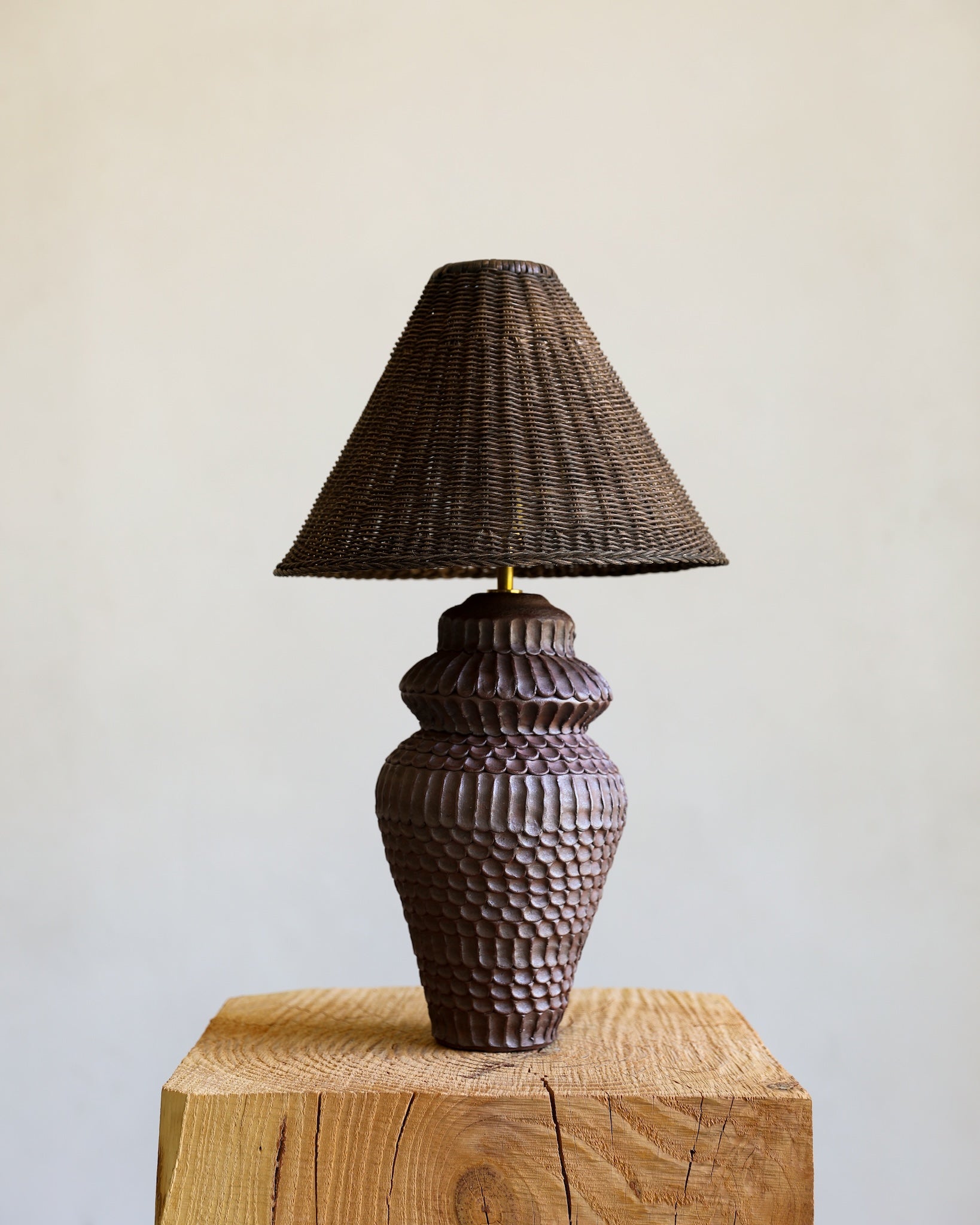 unglazed Fielding Clayworks handmade ceramic textured table lamp with custom wicker shade and raw brass fittings