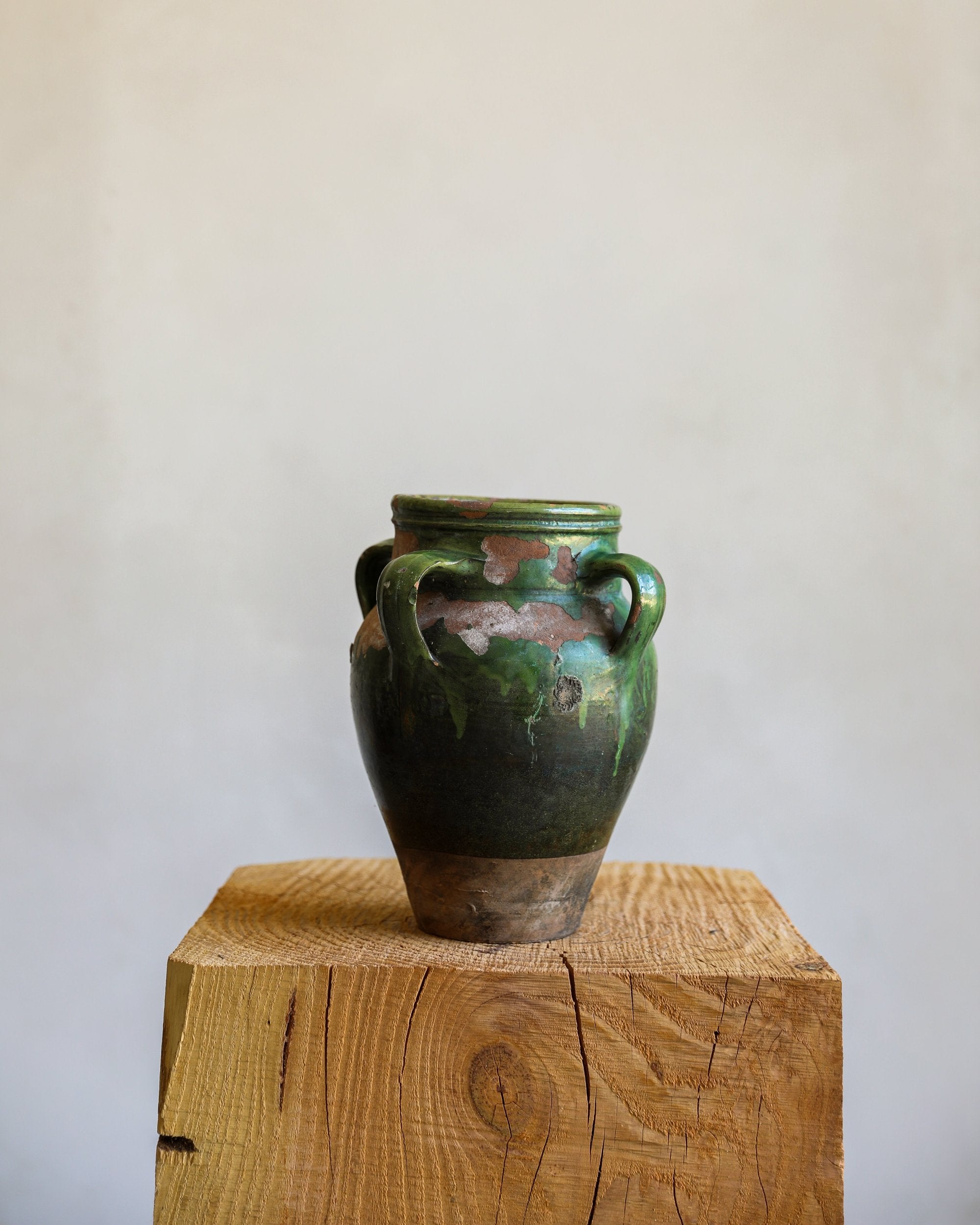 three handled vintage antique glazed green terracotta pot with chipping and patina
