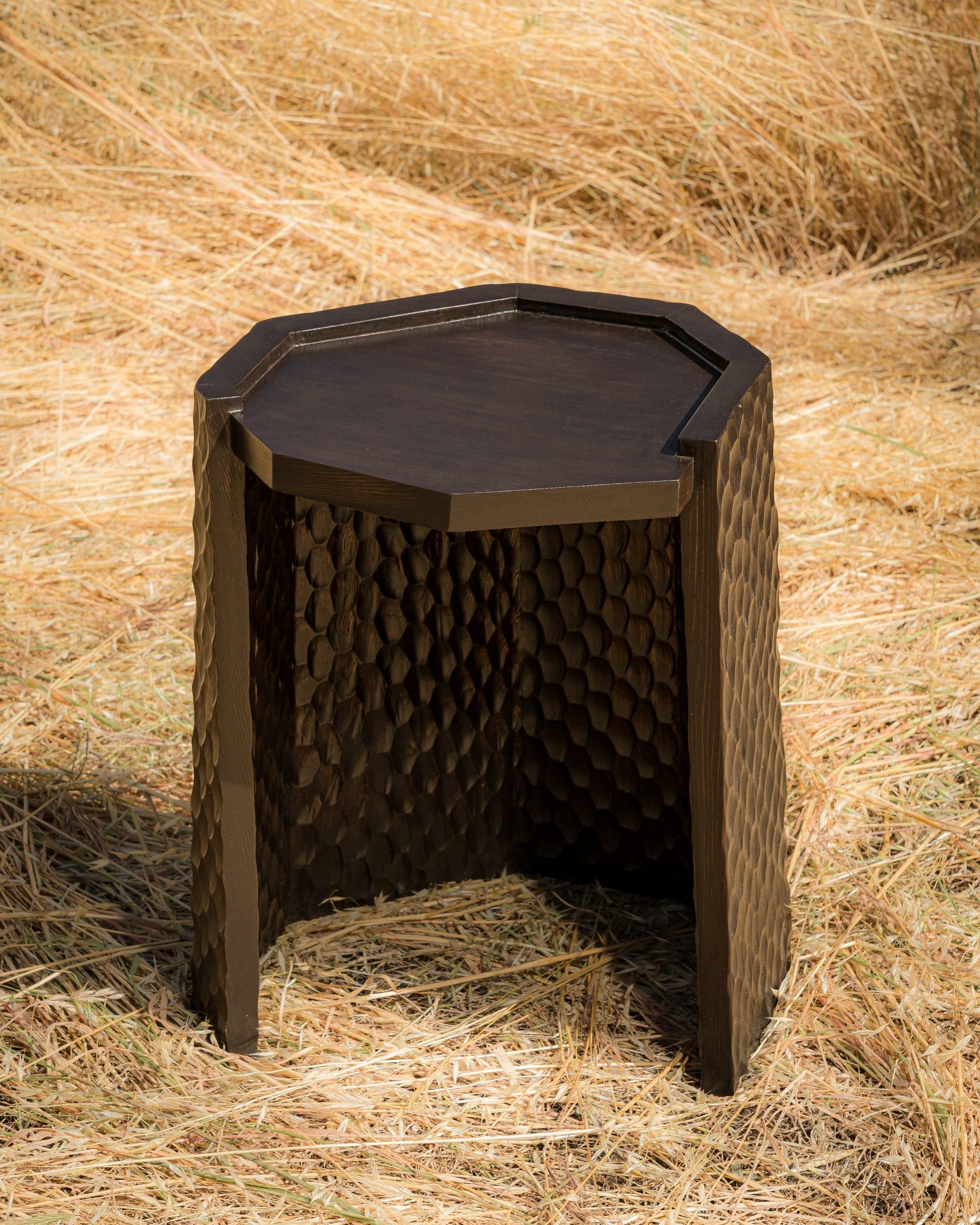 carved wood haus of hommeboys ocotillo side table in sonoma field