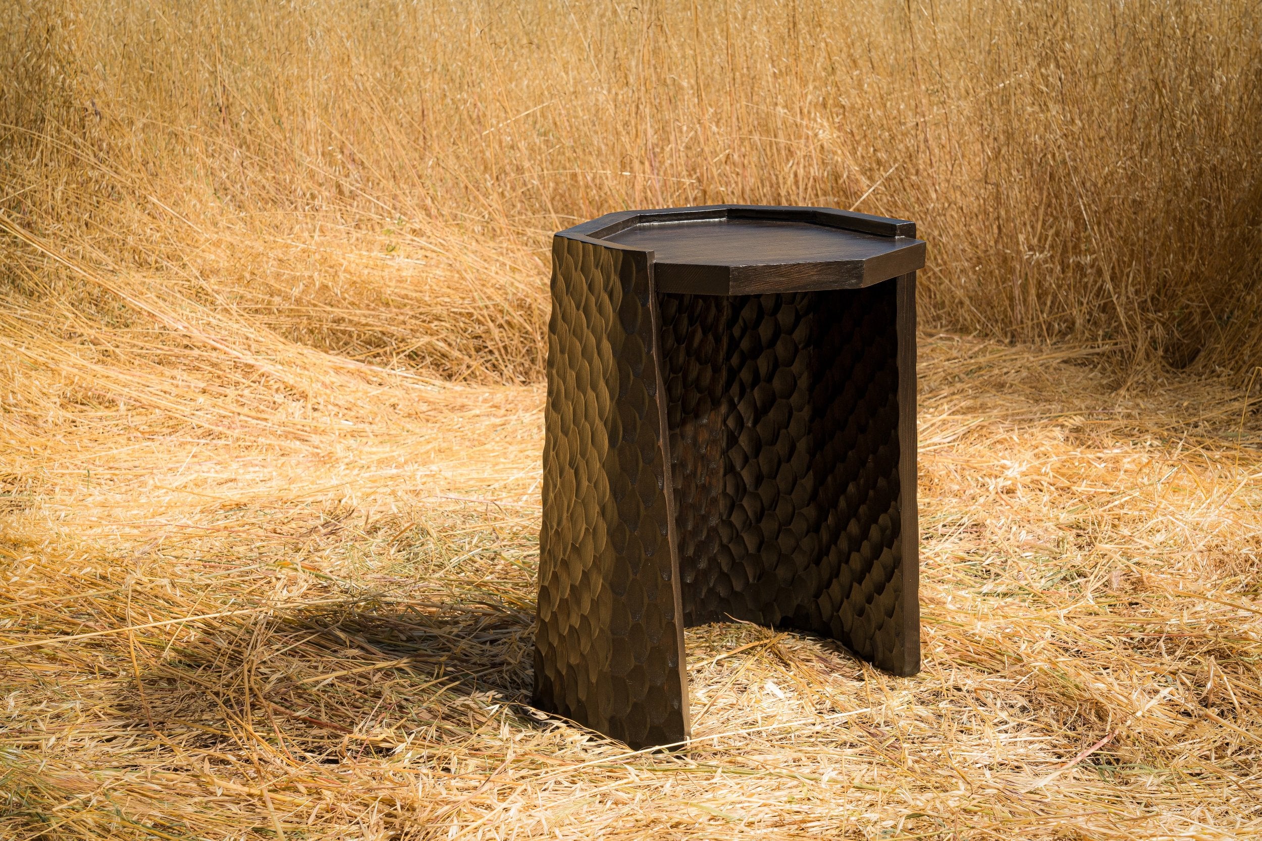 carved wood haus of hommeboys ocotillo side table in sonoma field