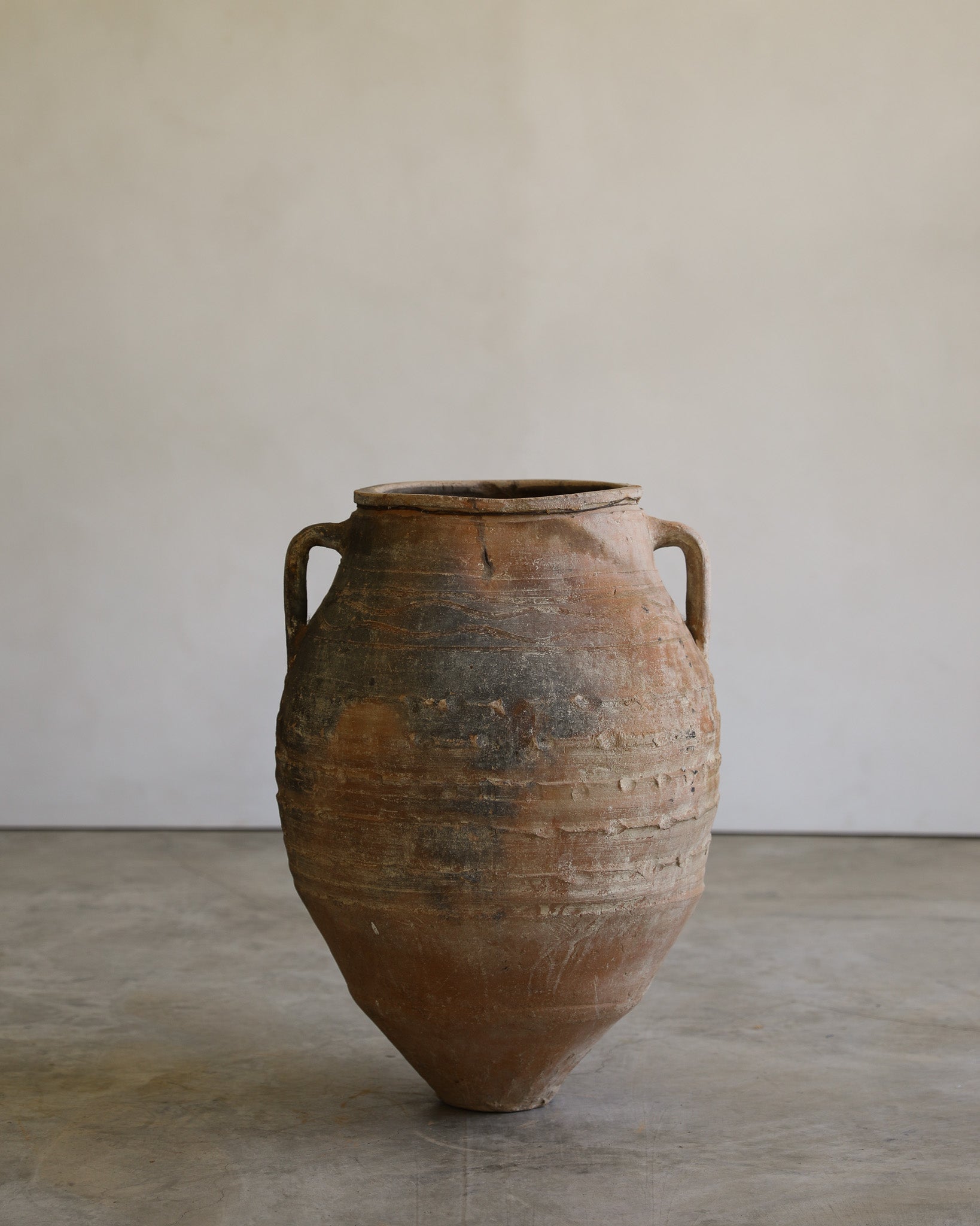 antique turkish handled olive jar with etching details and metal stand