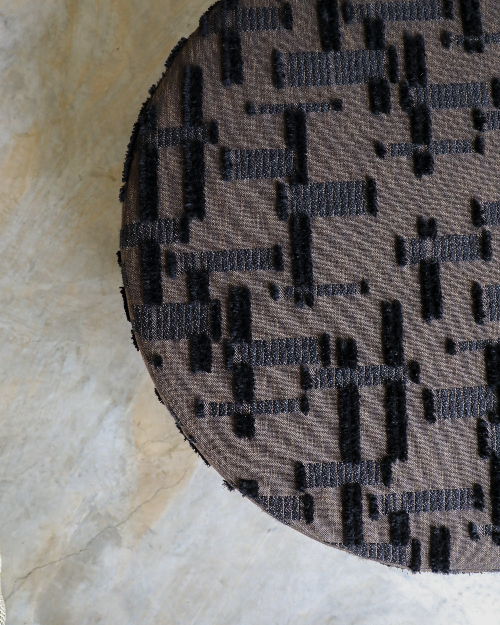 haus of hommeboys rubelli berber fabric detail on round bishop ottoman