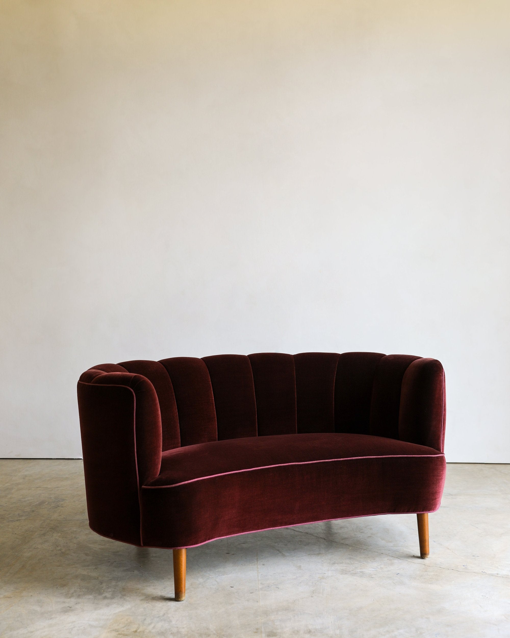 vintage reupholstered velvet channel tufted settee sofa with wooden feet side detail