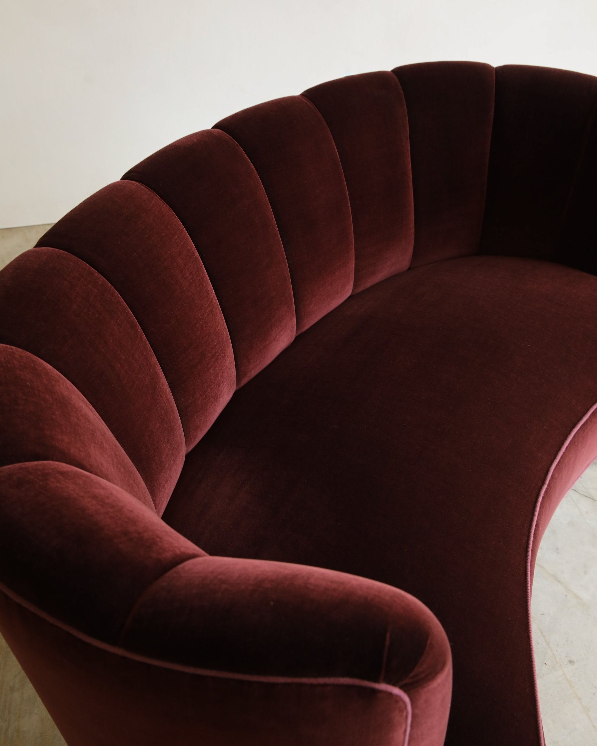 vintage reupholstered velvet channel tufted settee sofa with wooden feet overhead detail