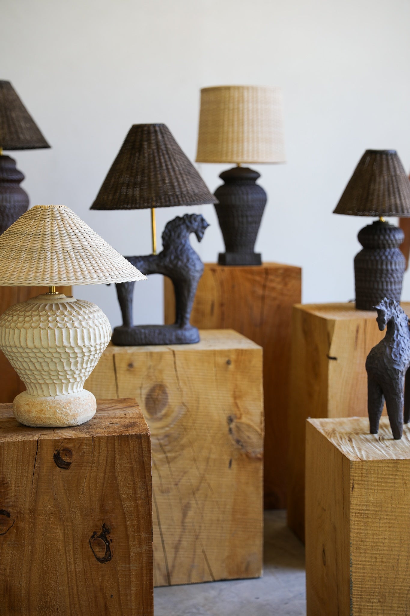 fielding clayworks textured ceramic table lamps natural and dark wicker lamp shades on wooden stumps detail