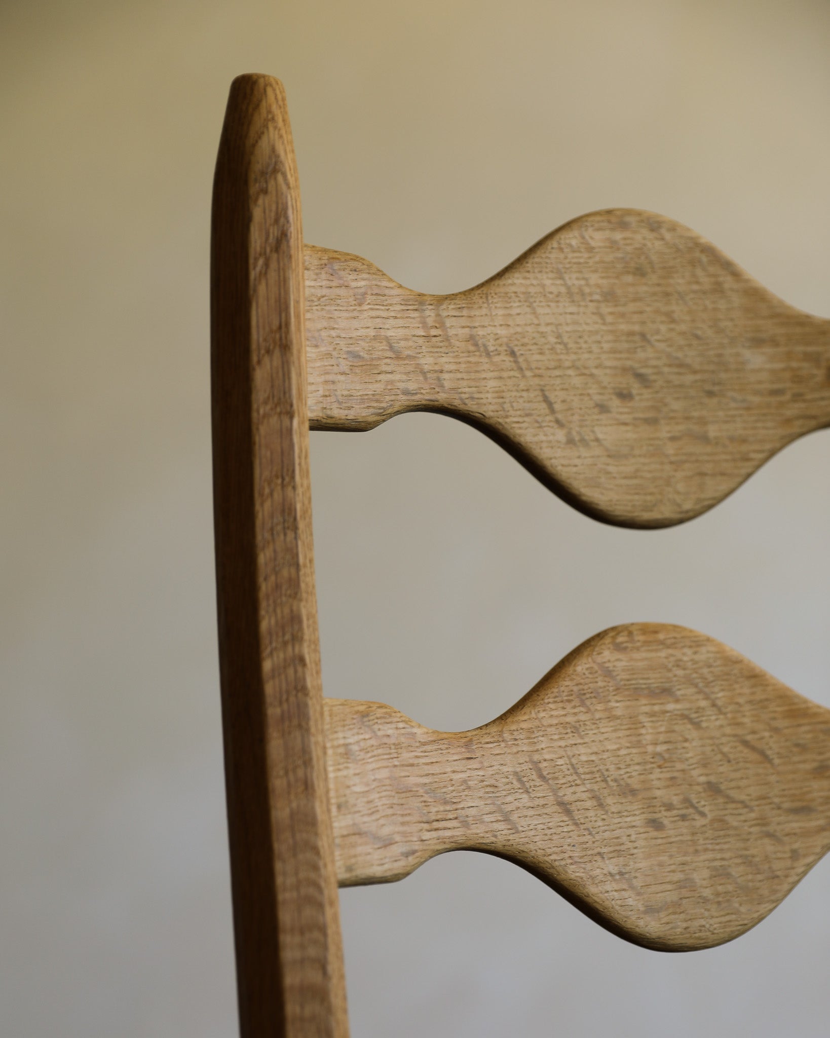 vintage carved oak chair detail on beige background