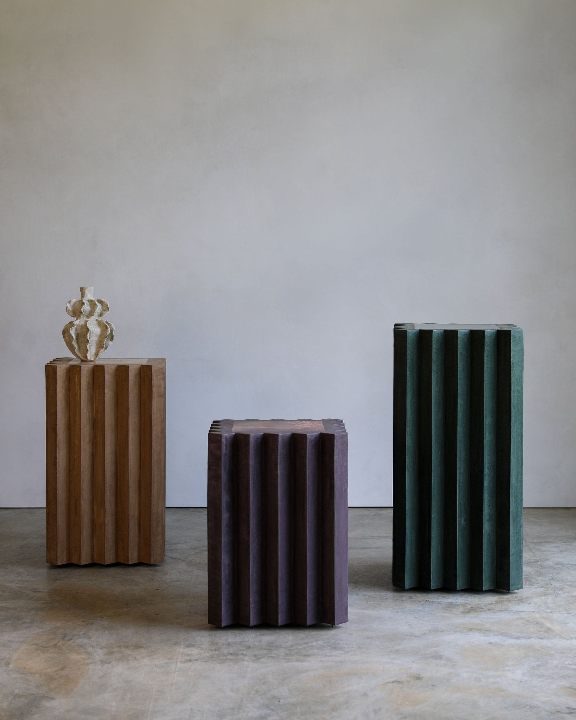 haus of hommeboys lone pedestals in green purple and tan faceted vert aubergine and buff plaster with marble insets