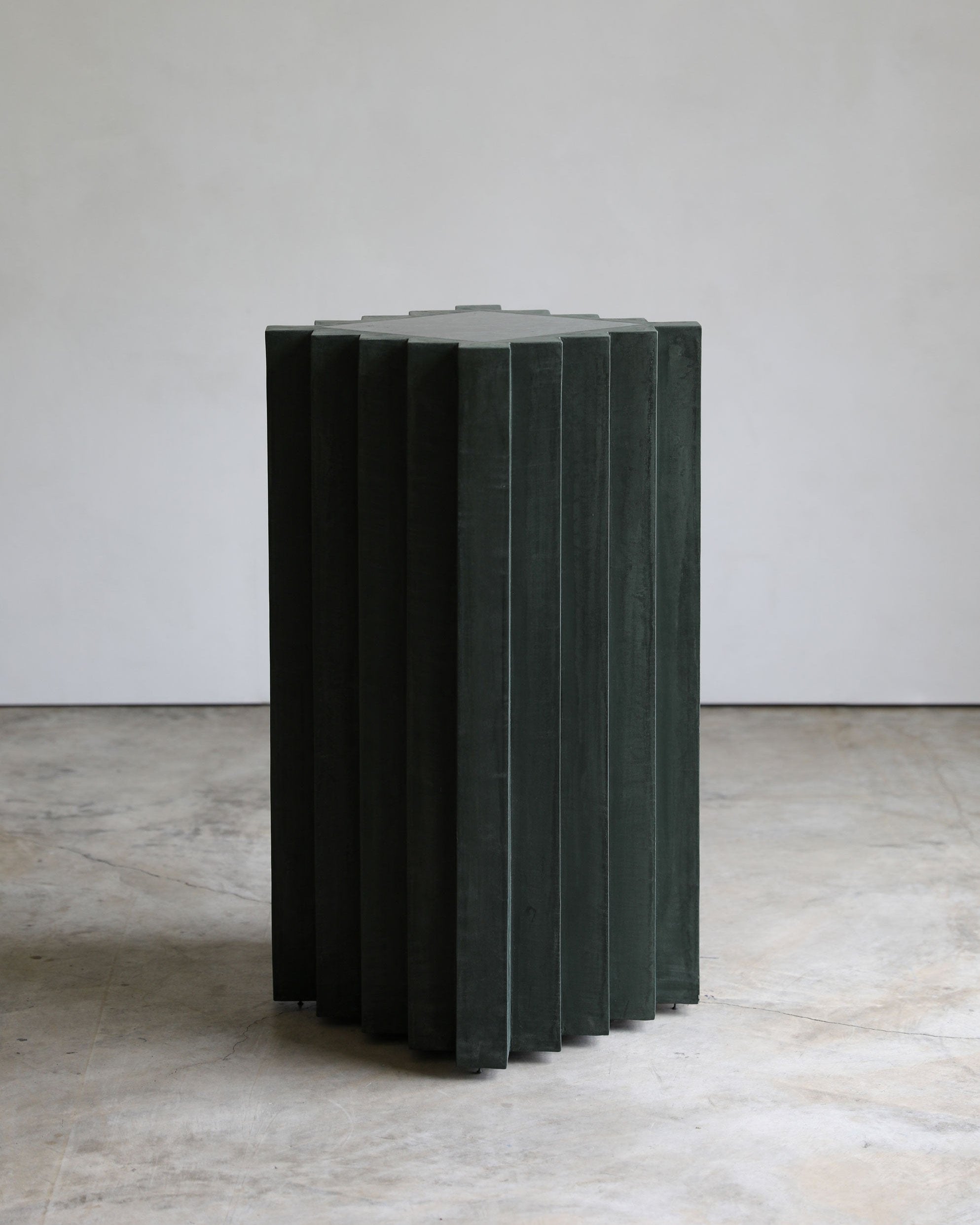 haus of hommeboys lone pedestal in green vert plaster and marble angle view