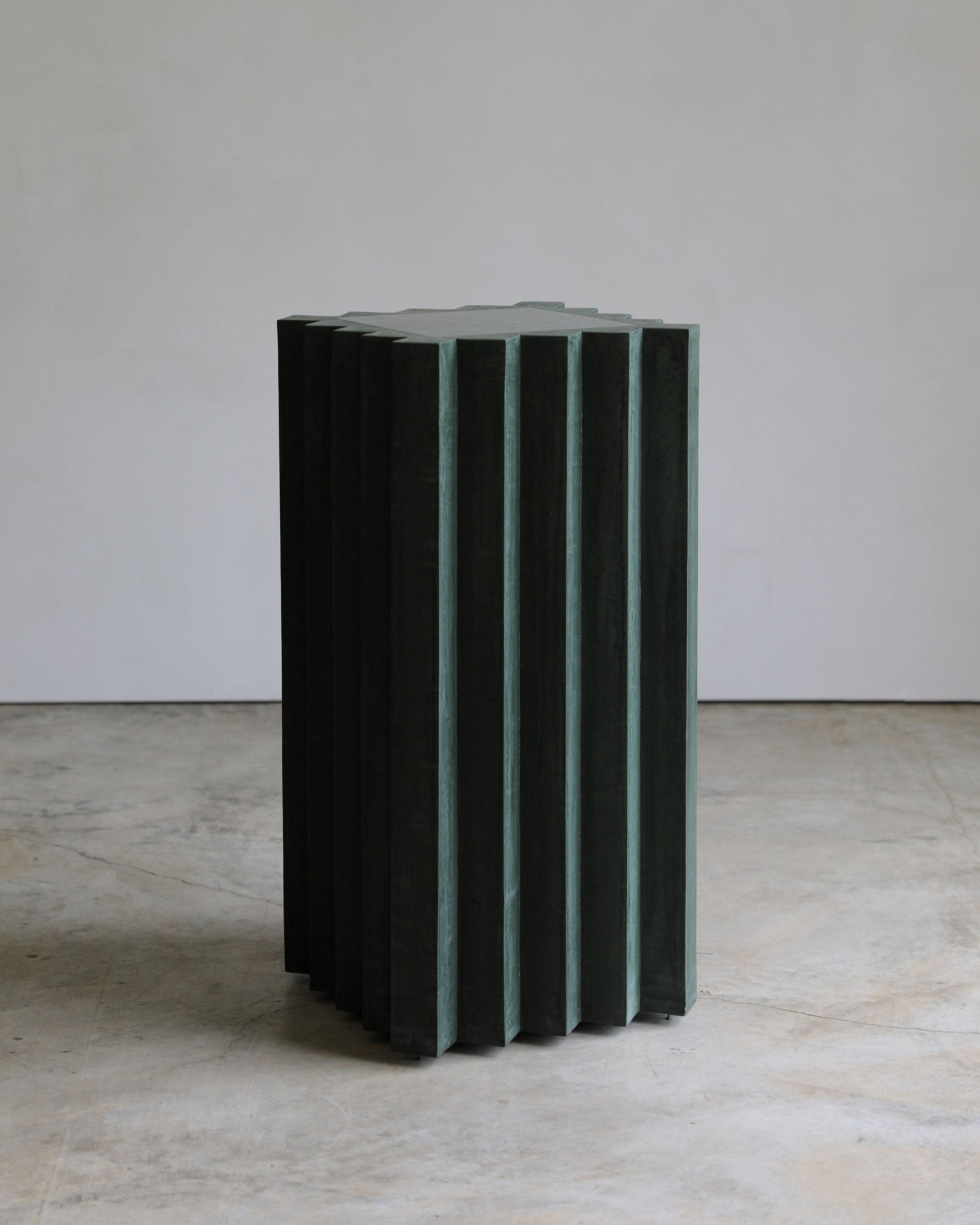 haus of hommeboys lone pedestal in green faceted vert plaster with marble inset