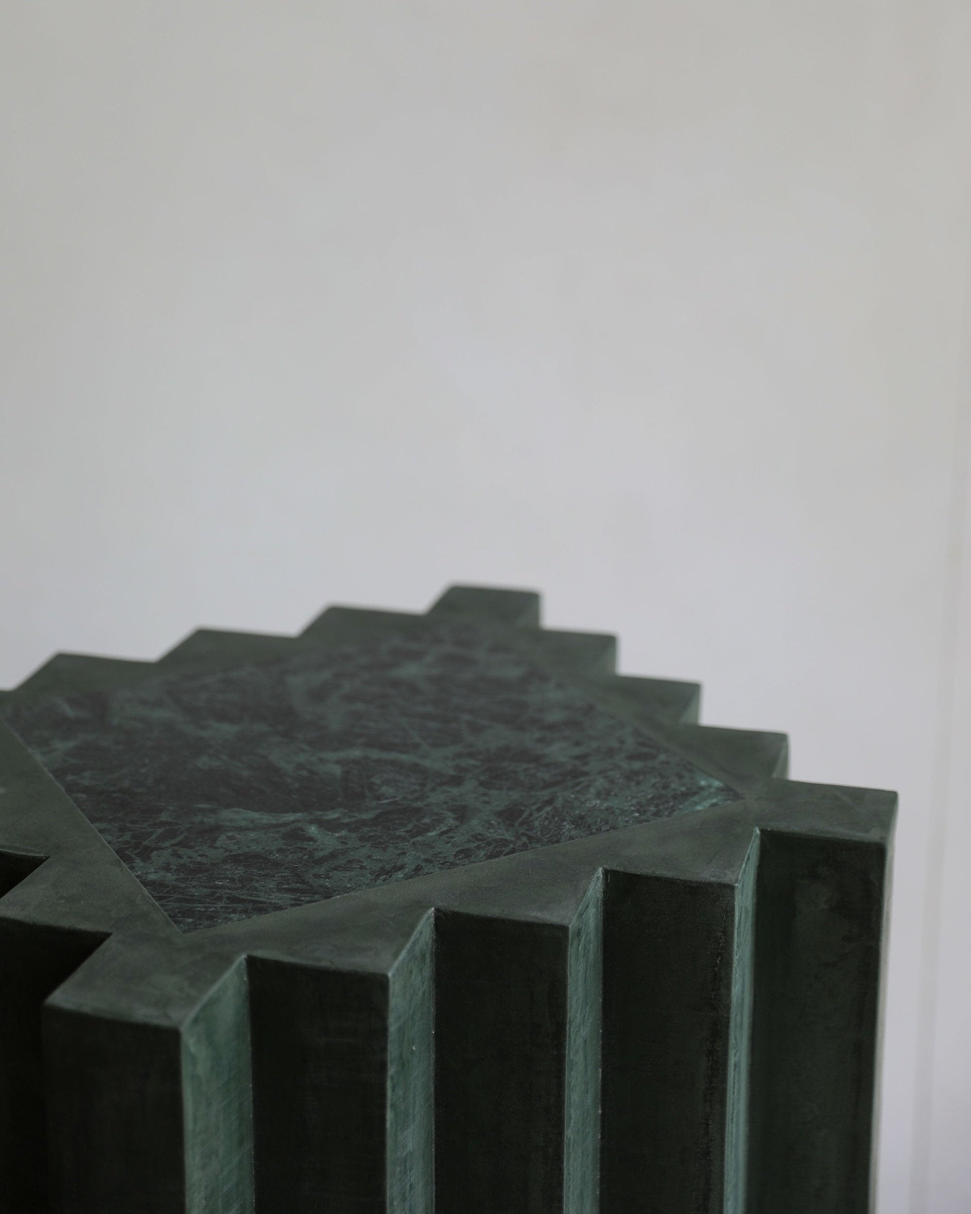 haus of hommeboys lone pedestal in green faceted vert plaster with marble inset