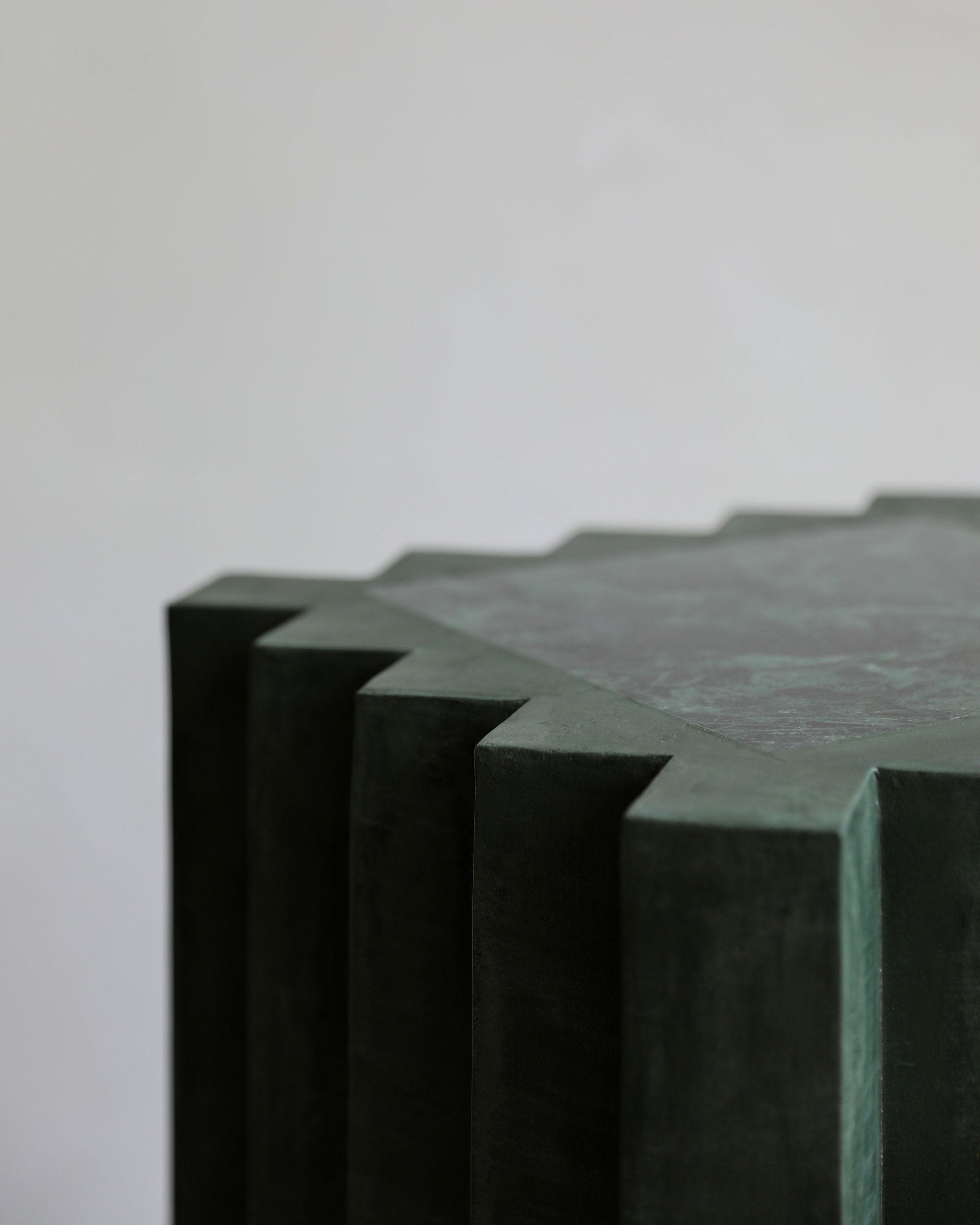 haus of hommeboys lone pedestal in green faceted vert plaster with marble inset