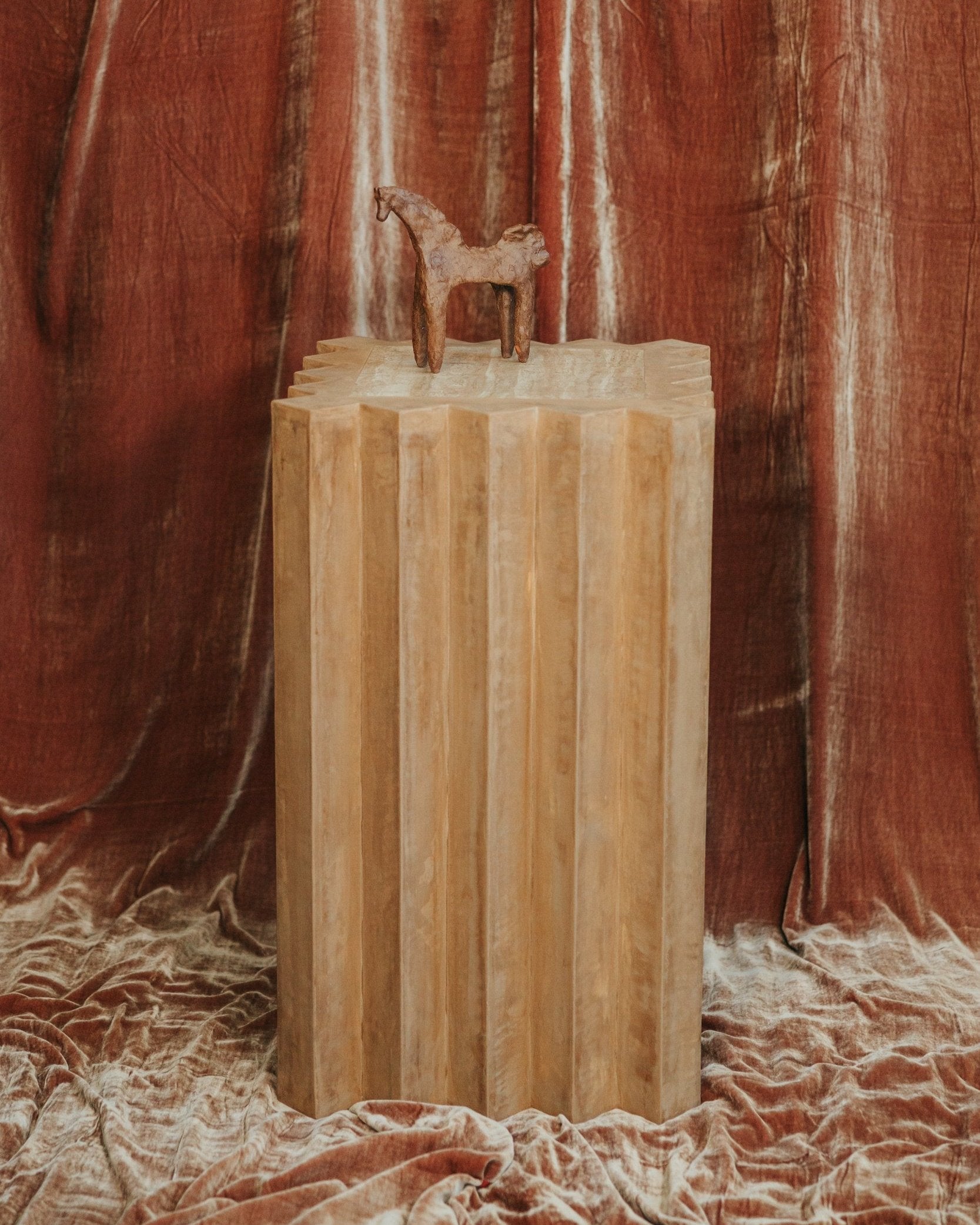 haus of hommeboys lone pedestal in buff plaster and travertine inset with velvet background and Fielding Clayworks horse