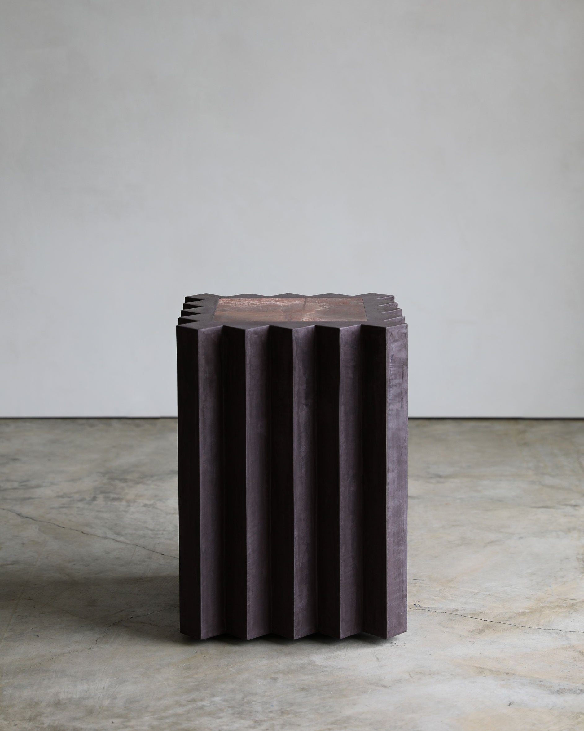 haus of hommeboys small lone pedestal in aubergine faceted purple plaster with red marble inset