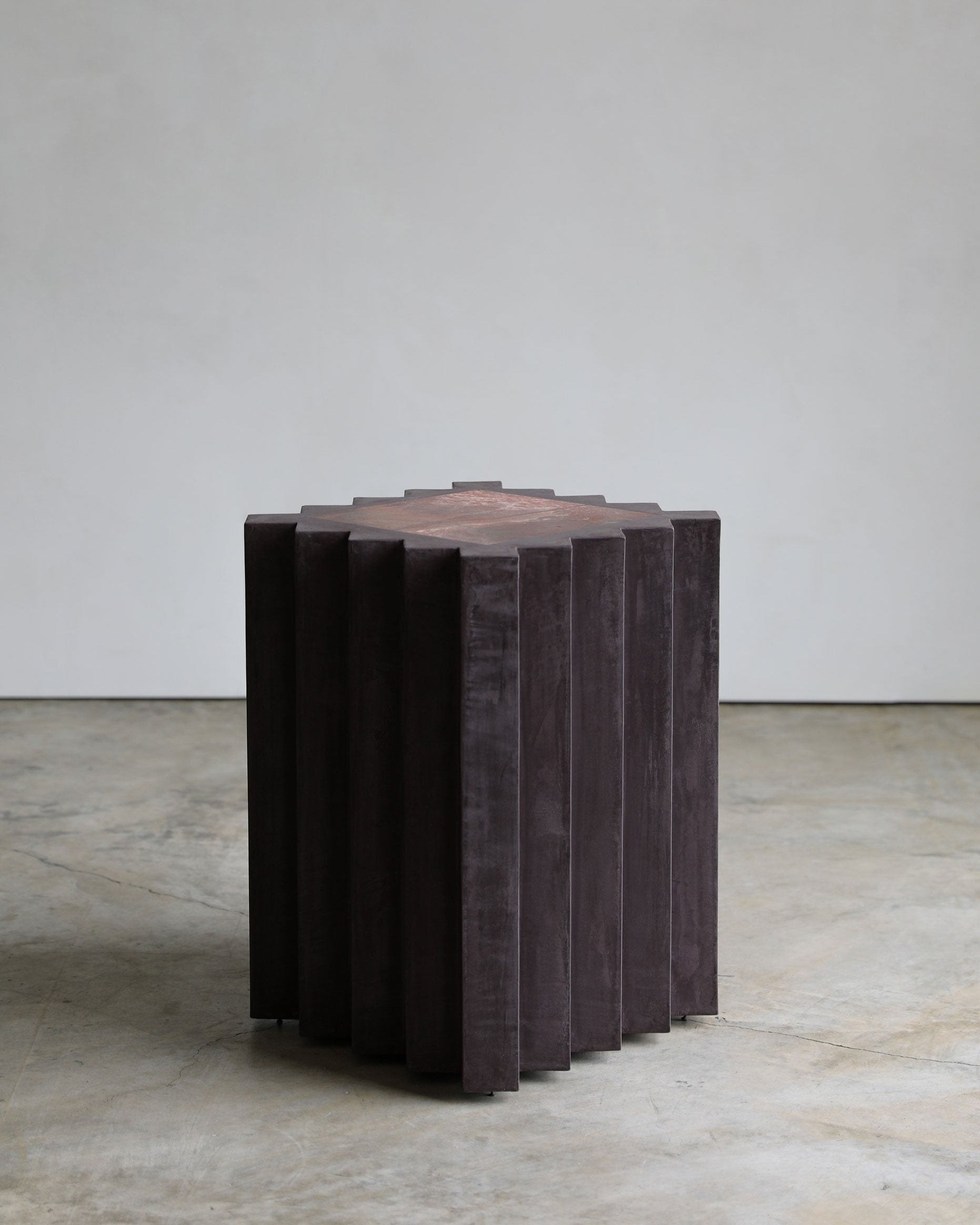 haus of hommeboys small lone pedestal in aubergine faceted purple plaster with red marble inset