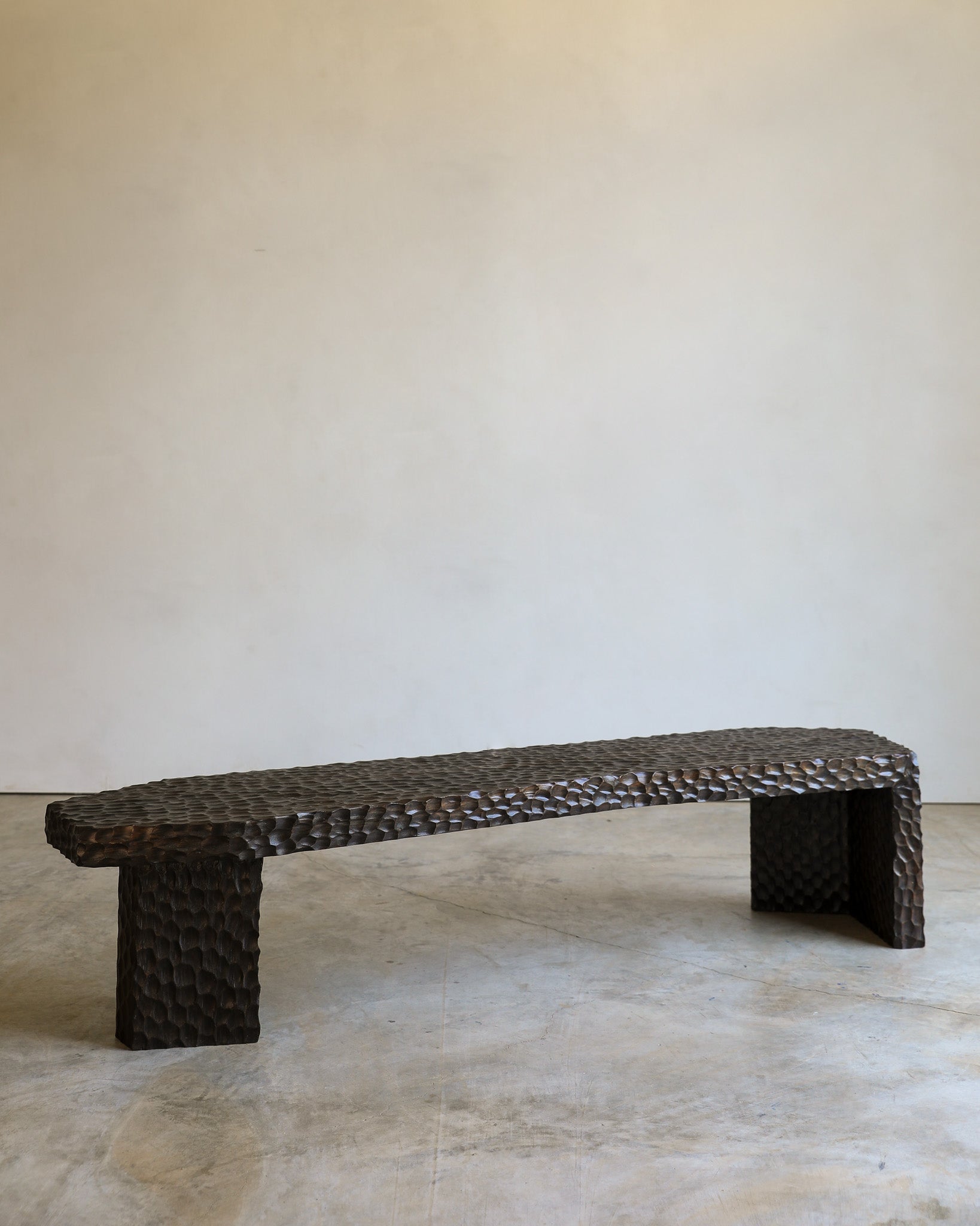 carved wood haus of hommeboys ocotillo bench in studio