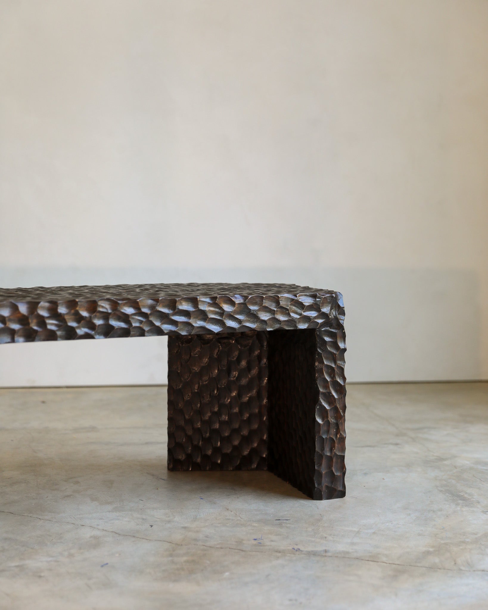 carved wood haus of hommeboys ocotillo bench in studio