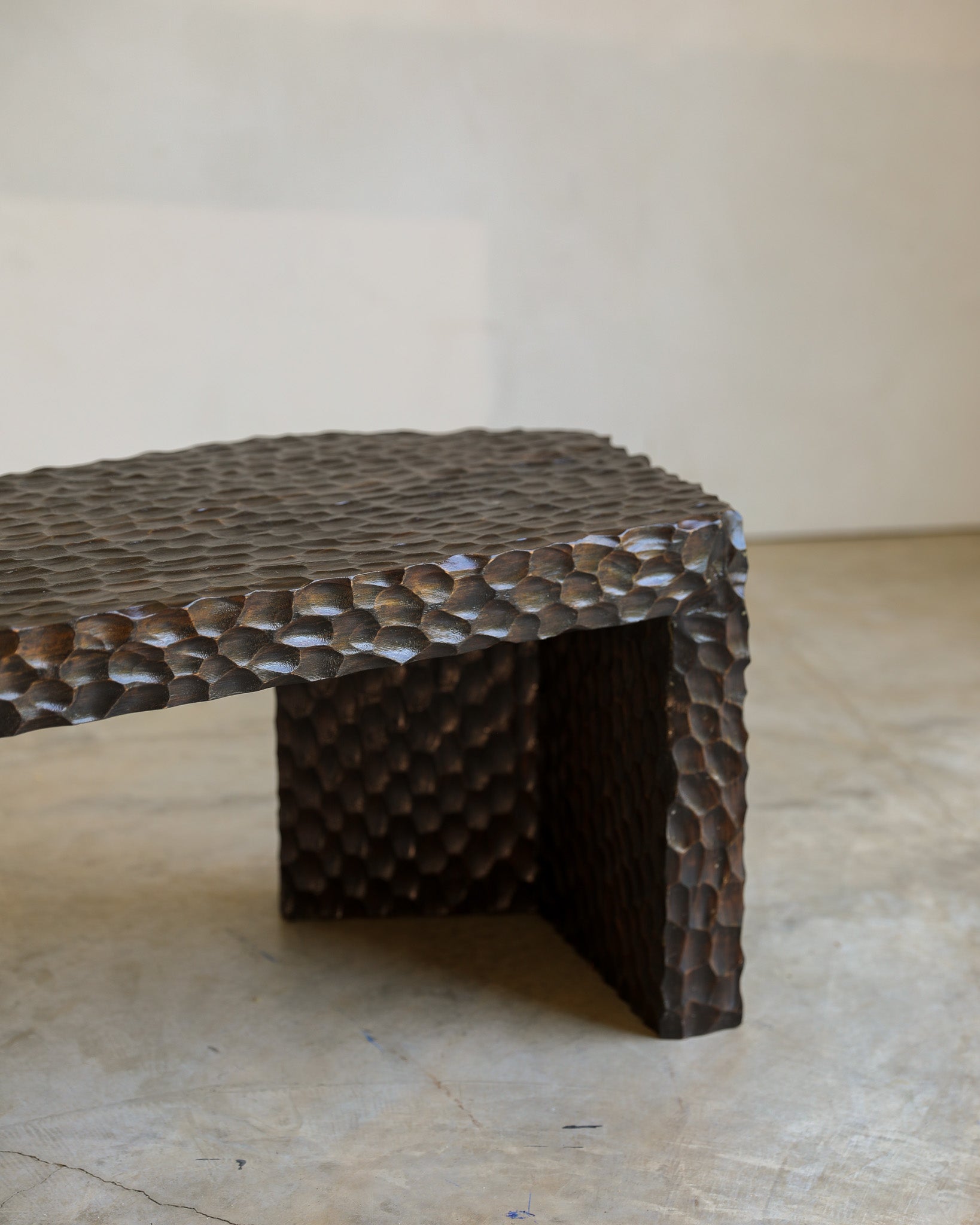 carved wood haus of hommeboys ocotillo bench in studio