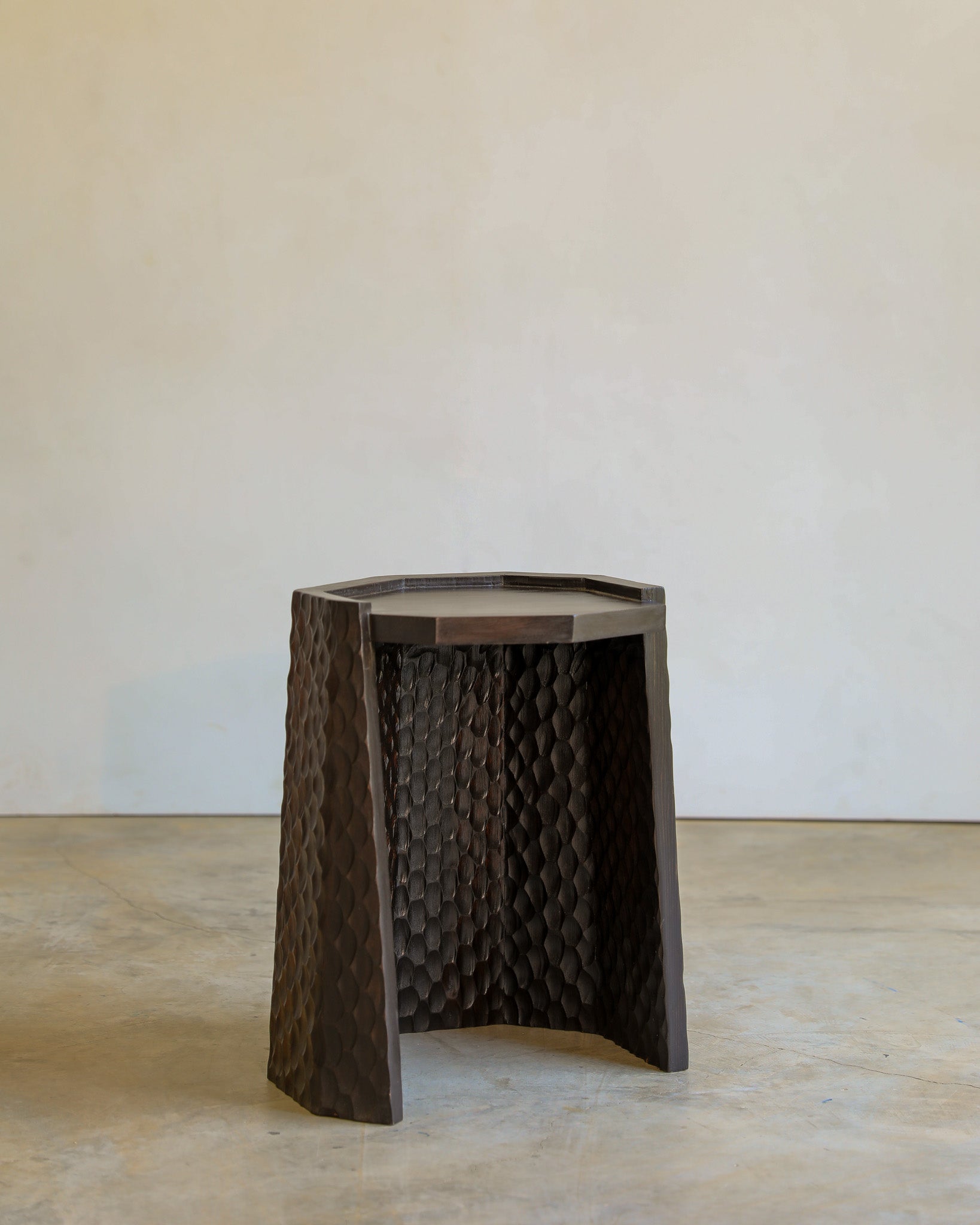 carved wood haus of hommeboys ocotillo side table in studio