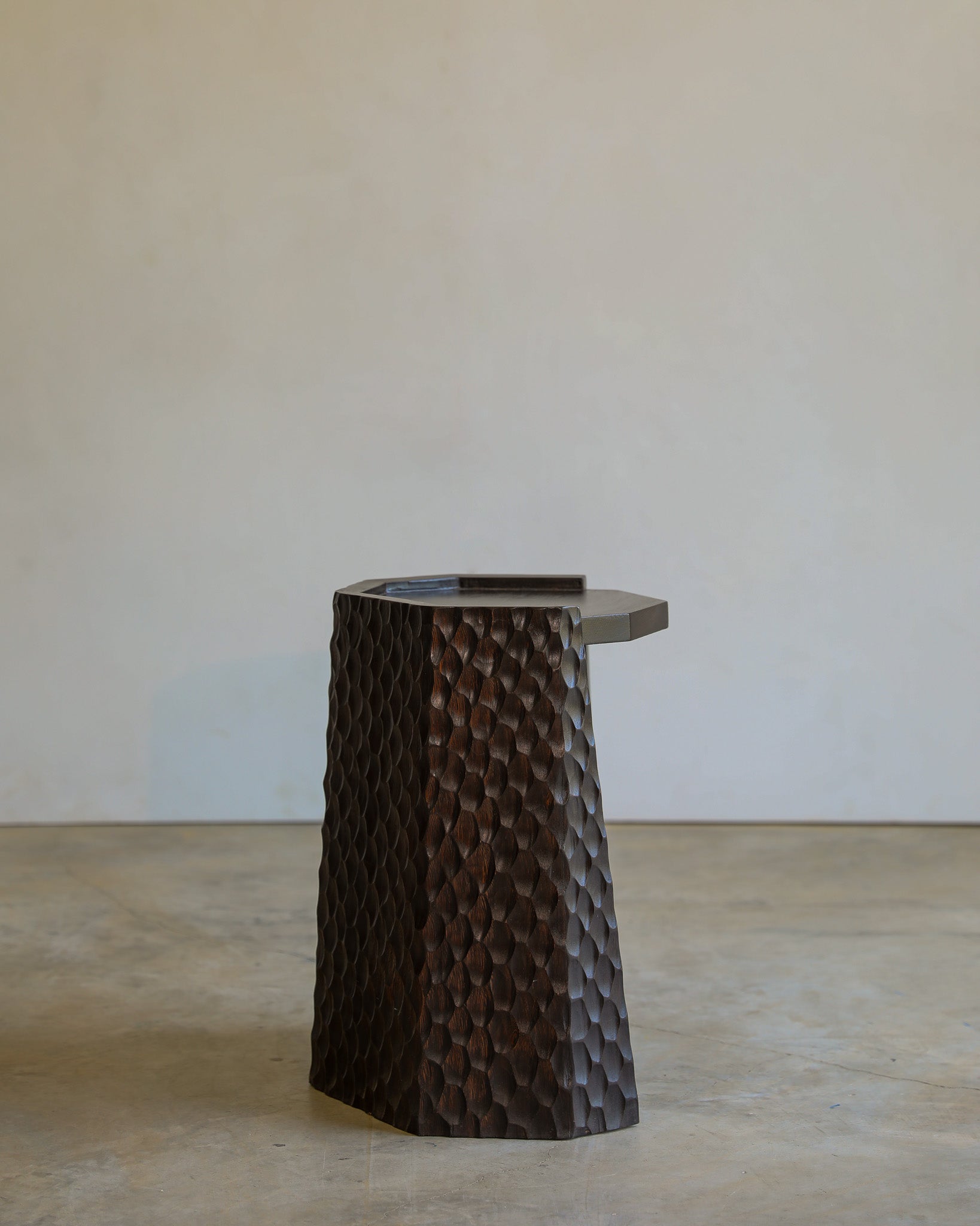 carved wood haus of hommeboys ocotillo side table in studio