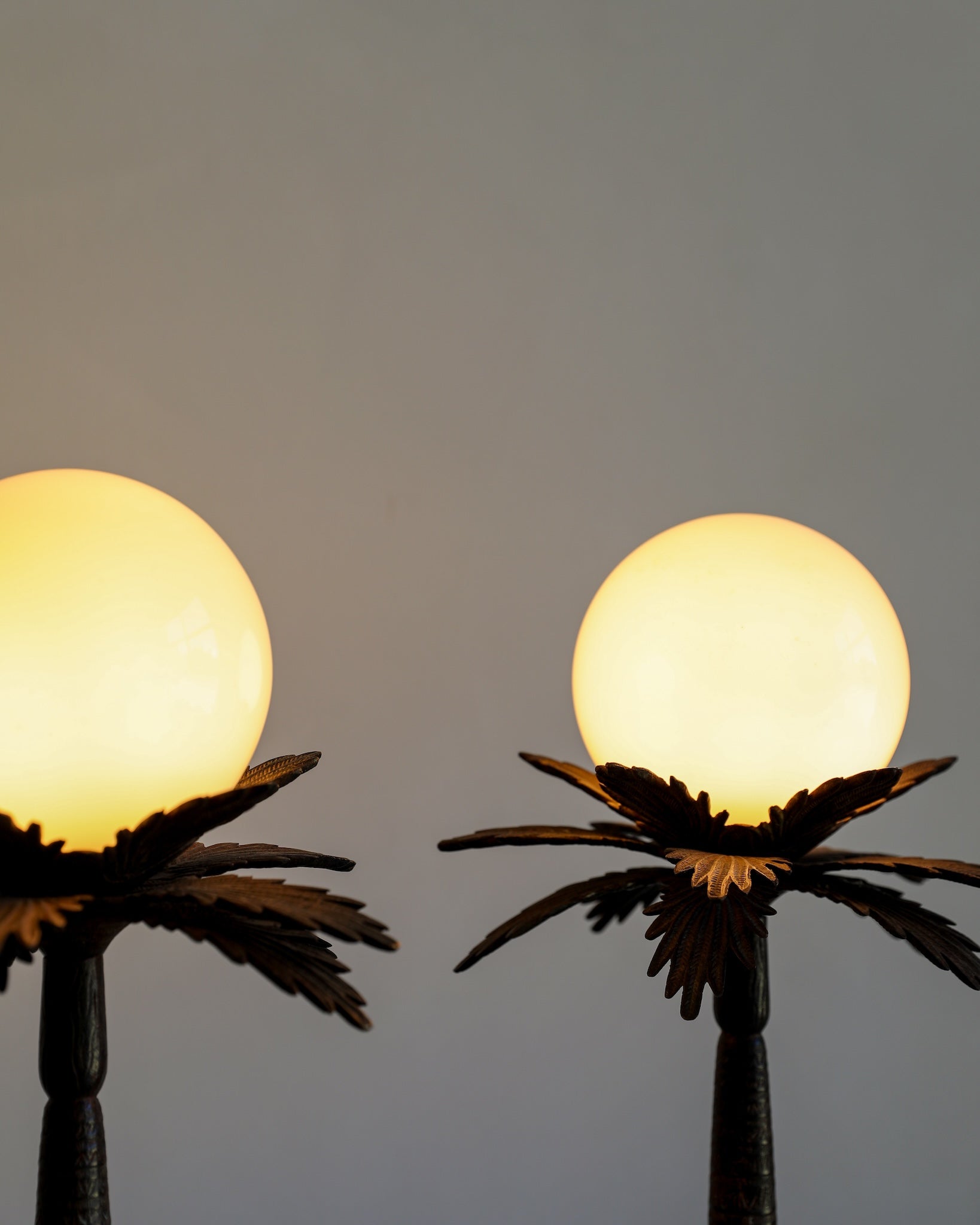 vintage hollywood regency bronze unique palm tree table lamp pair glass globe lights closeup on