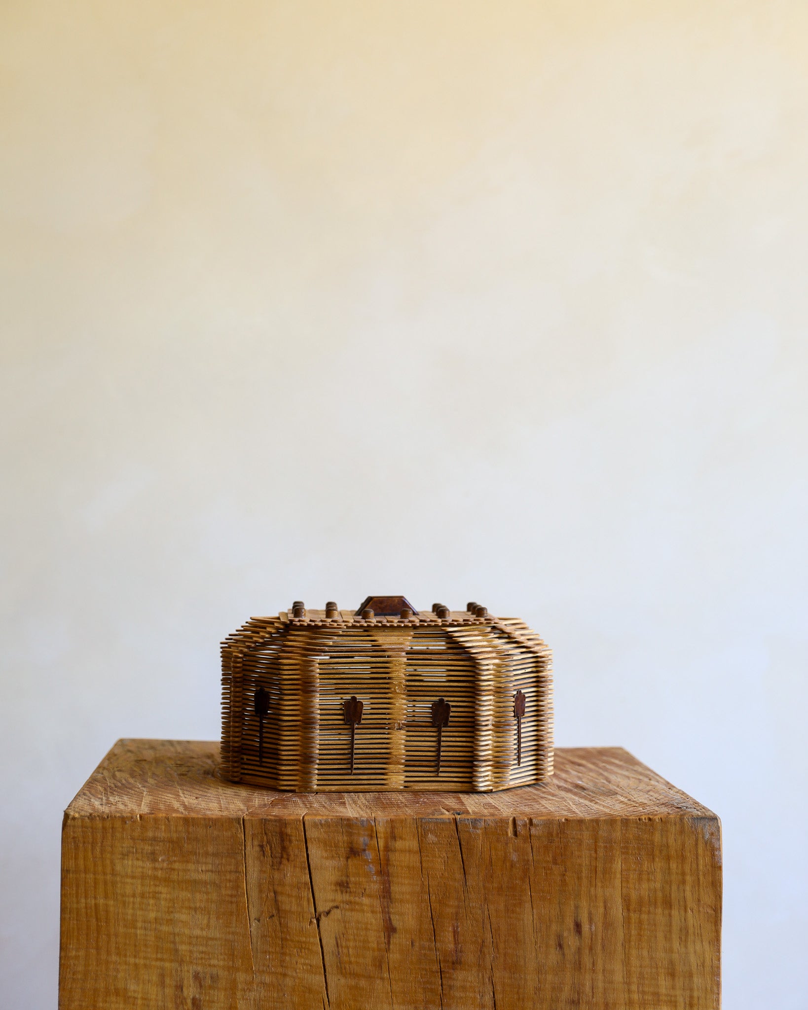 tramp art box made of popsicle sticks on wood stump