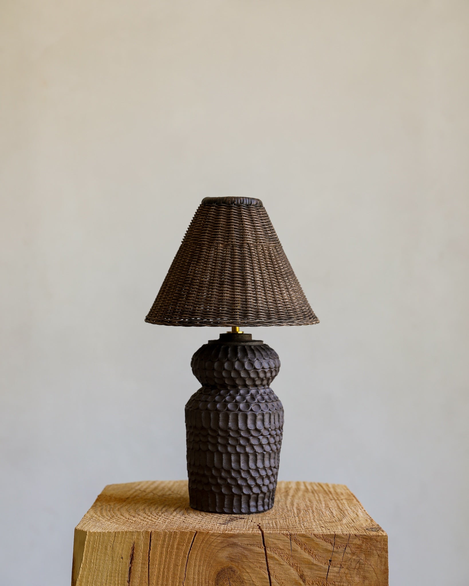 unglazed Fielding Clayworks handmade ceramic textured table lamp with custom wicker shade and raw brass fittings 