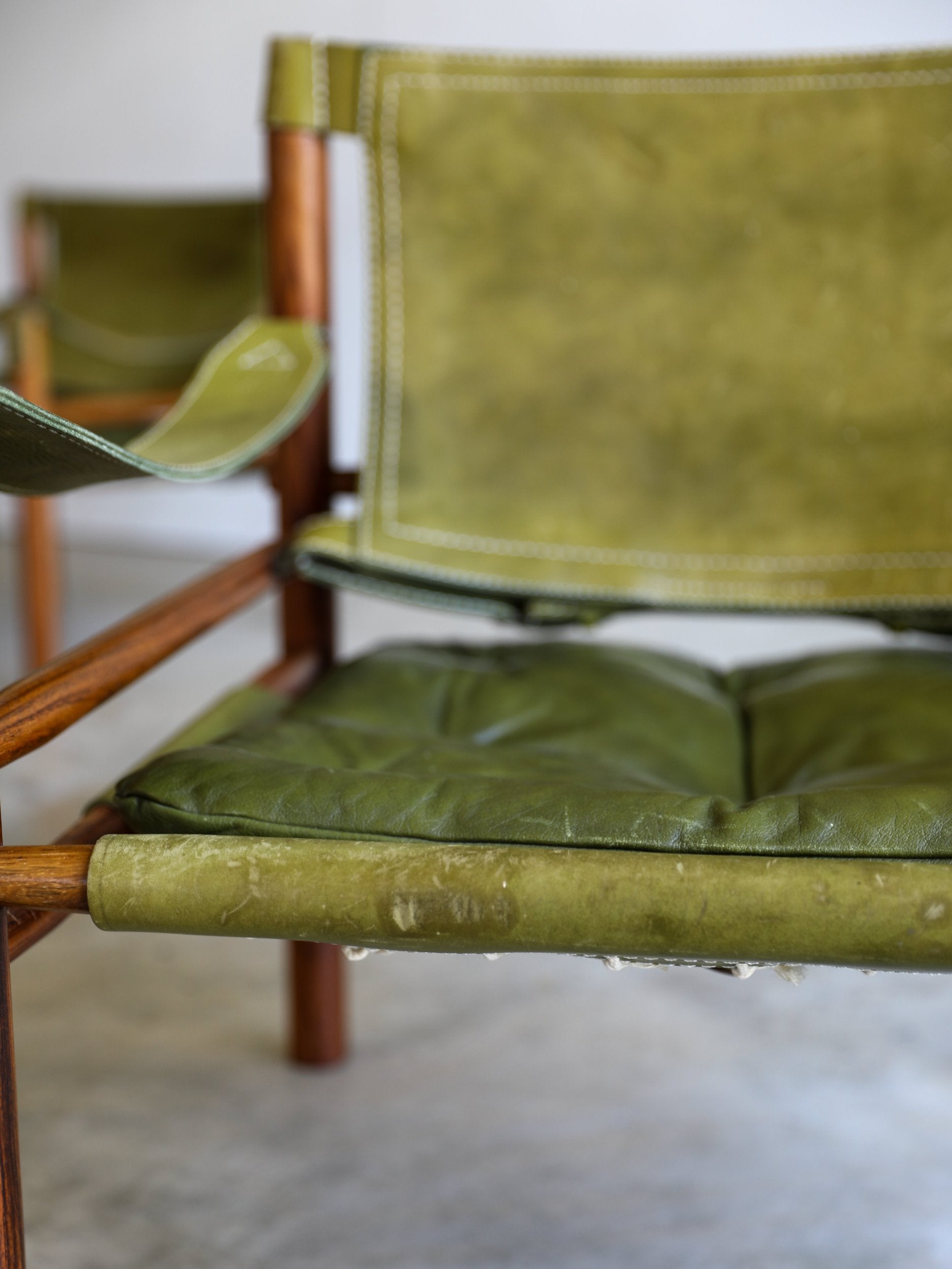 vintage swedish Arne Norell Sirocco Chair Pair in rosewood and original green leather upholstery front wear detail