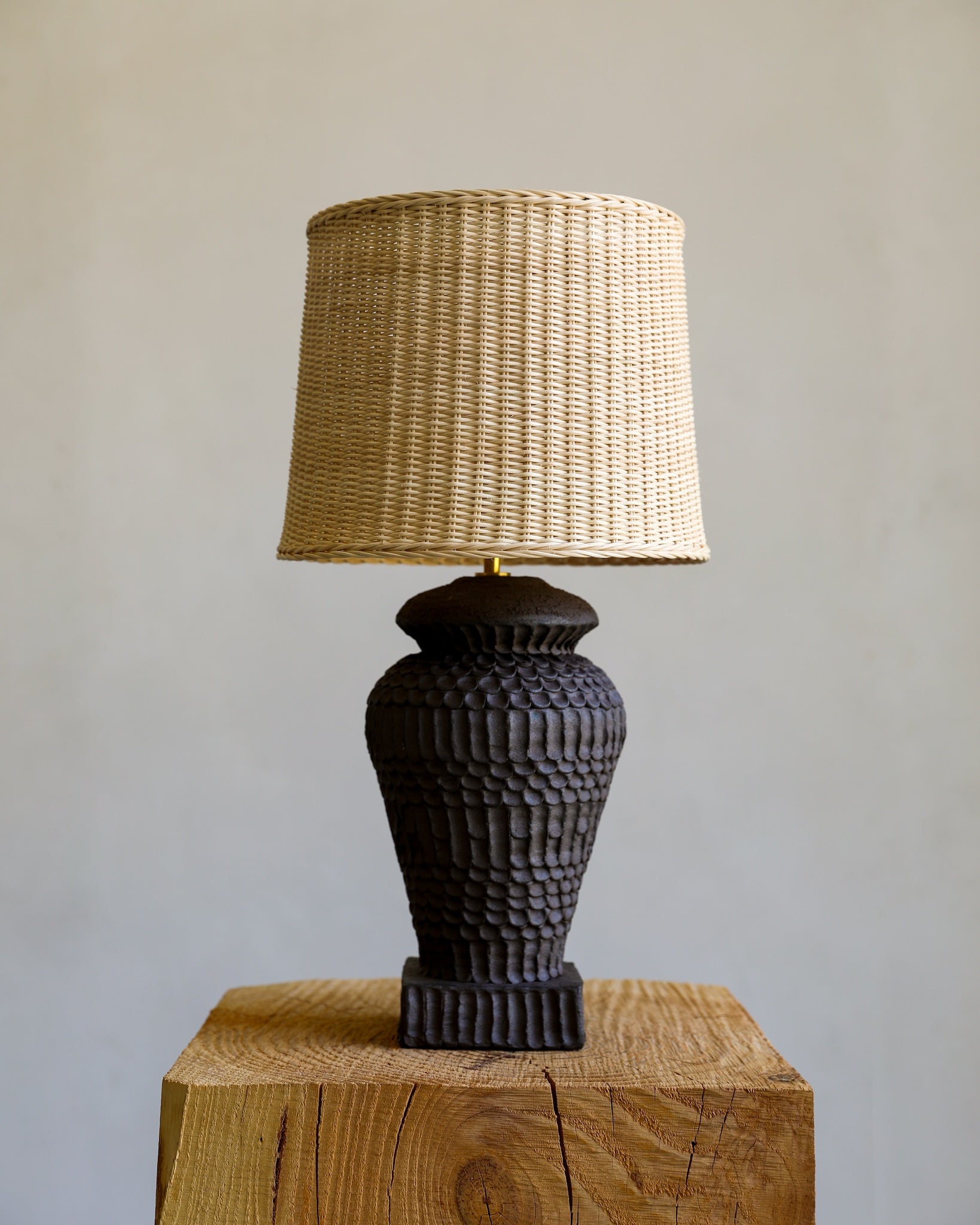 unglazed Fielding Clayworks handmade ceramic textured table lamp with custom wicker shade and raw brass fittings 