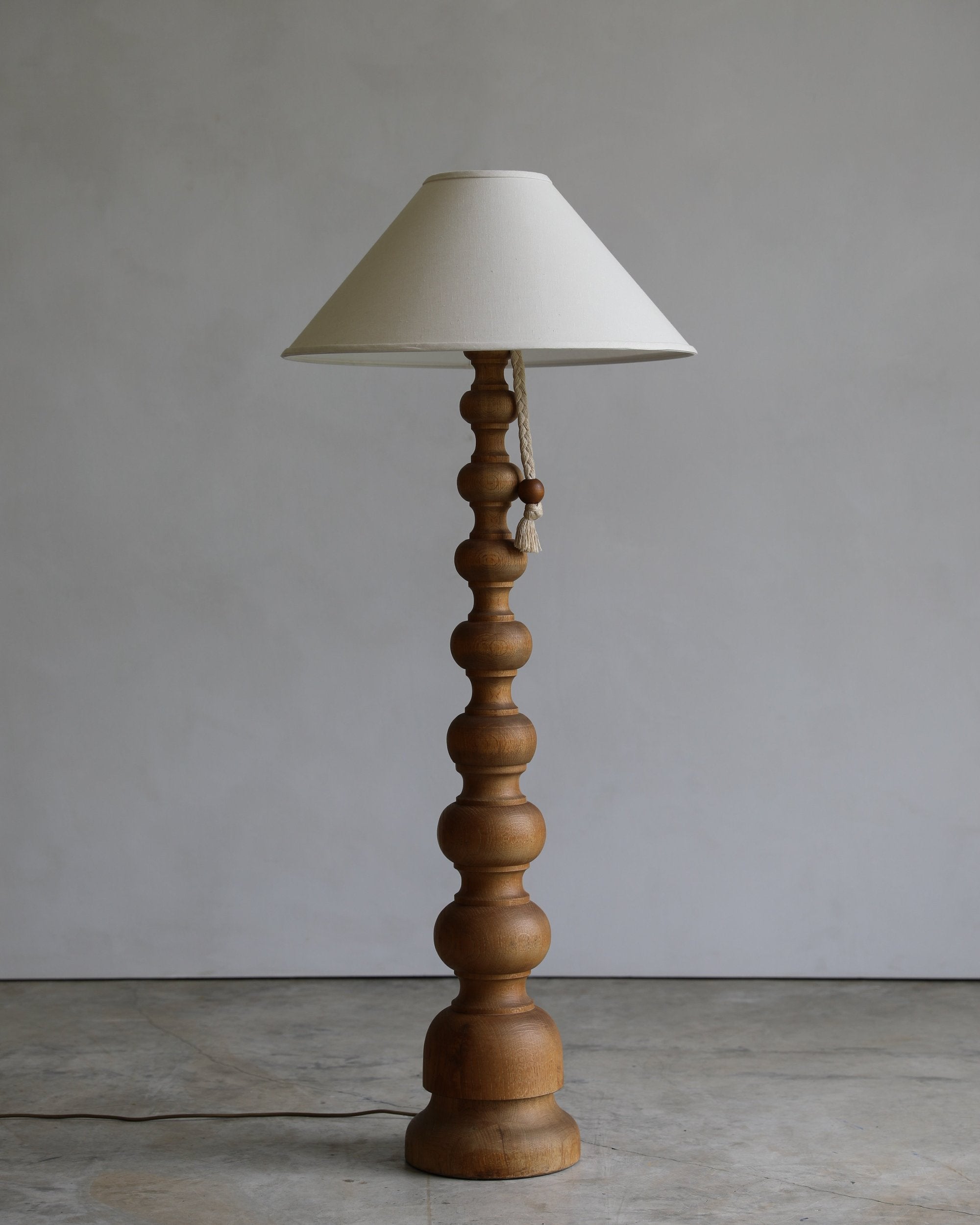 vintage turned wood floor lamp with rope pull detail and linen coolio shade